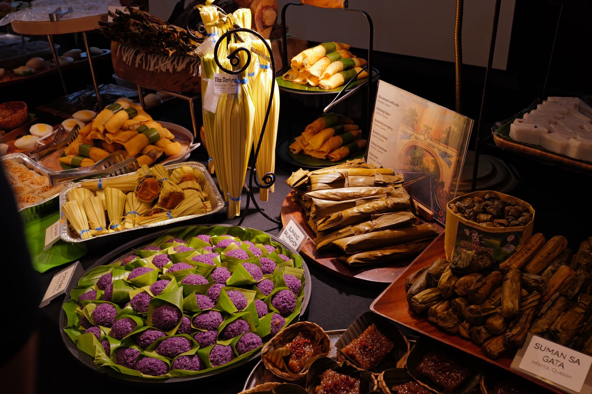 Suman bongon, banana-leaf suman, and other kakanin at the festival spread