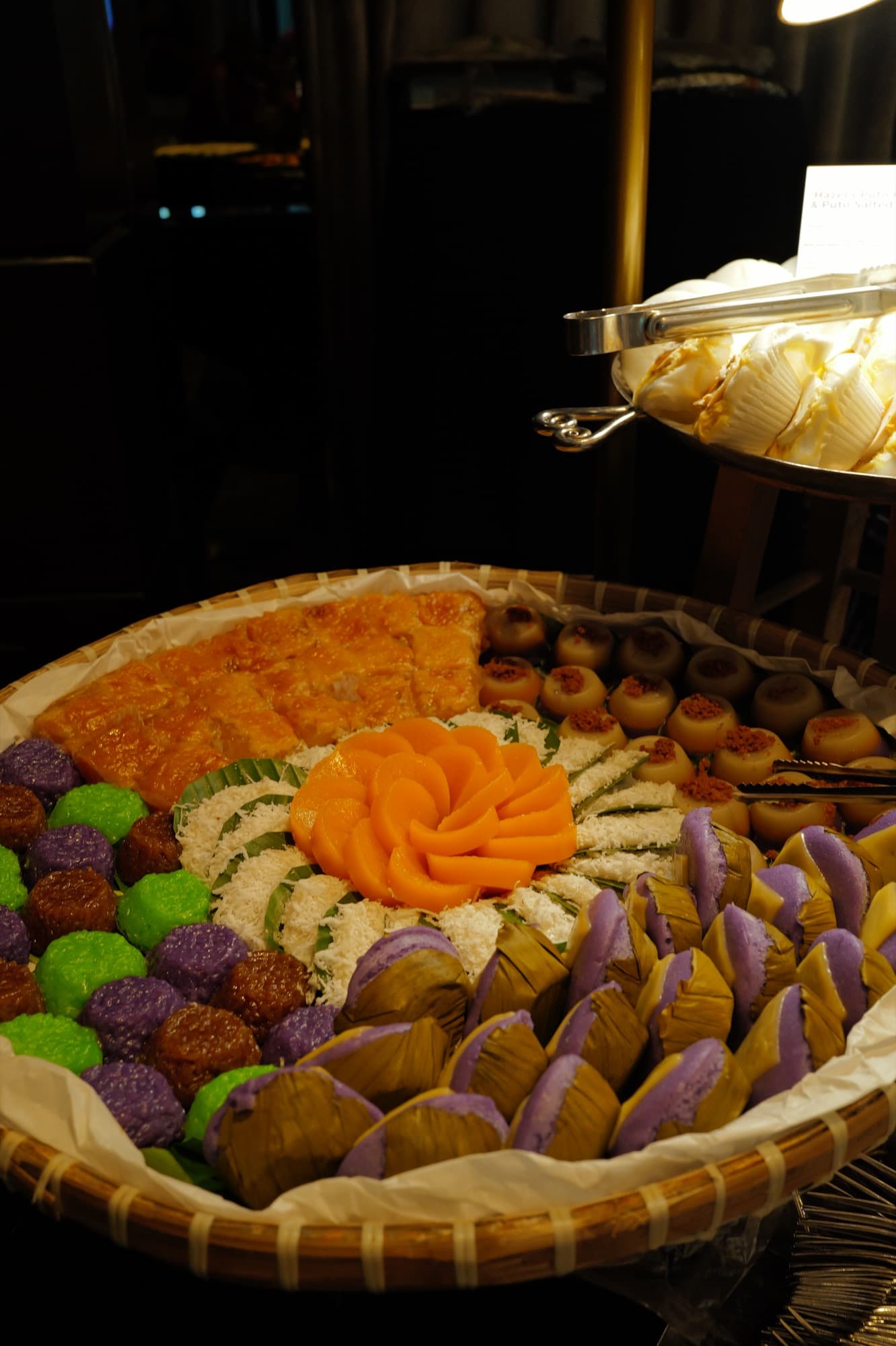A bilao of colorful kakanin arranged as a feast
